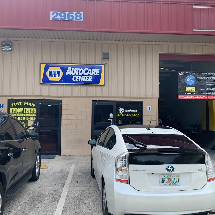 RepairTech Automotive shop exterior with NAPA AutoCare Center sign and Toyota Prius in Kissimmee FL